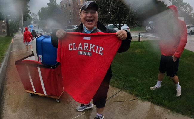 Family member of new Clark student proudly displays his Clarkie D shirt.