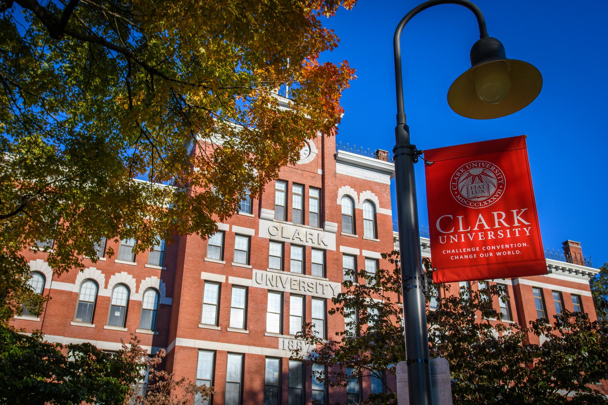 jonas clark hall with red clark university flag in foreground