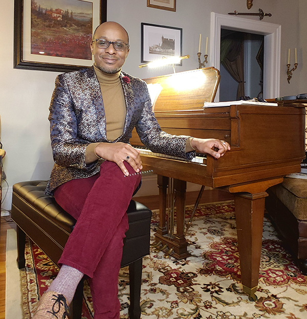 Cailin Marcel Manson sits at his piano