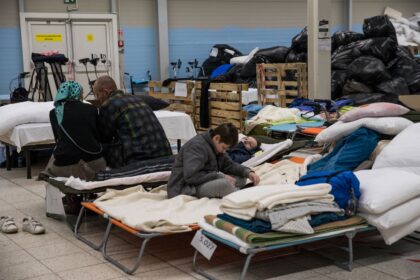 refugees on beds