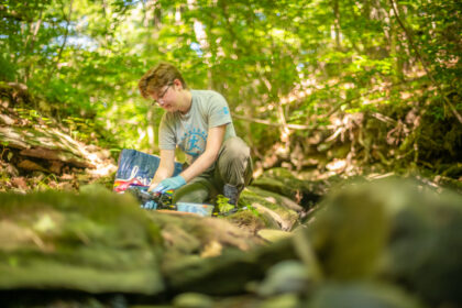 student collects water sample