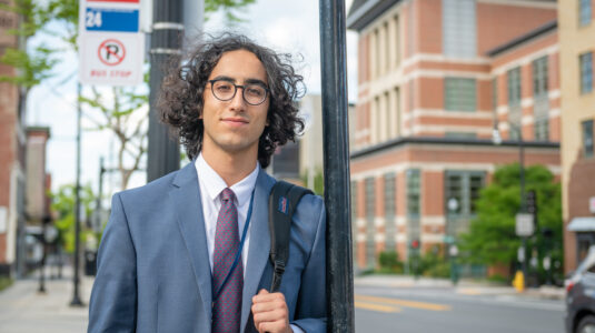 student on street outside courthouse