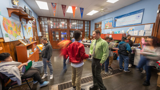 Principal Dan St. Louis ’00, M.Ed. ’01, greets students at the University Park Campus School