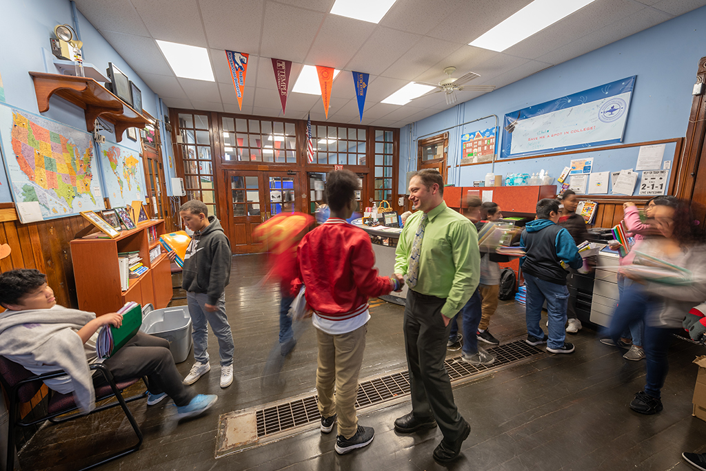 Principal Dan St. Louis ’00, M.Ed. ’01, greets students at the University Park Campus School