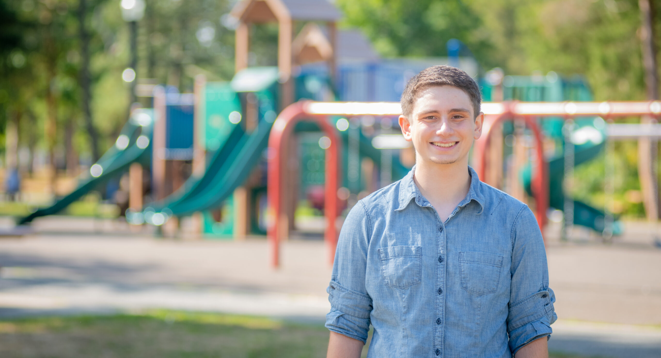 student at park with playground