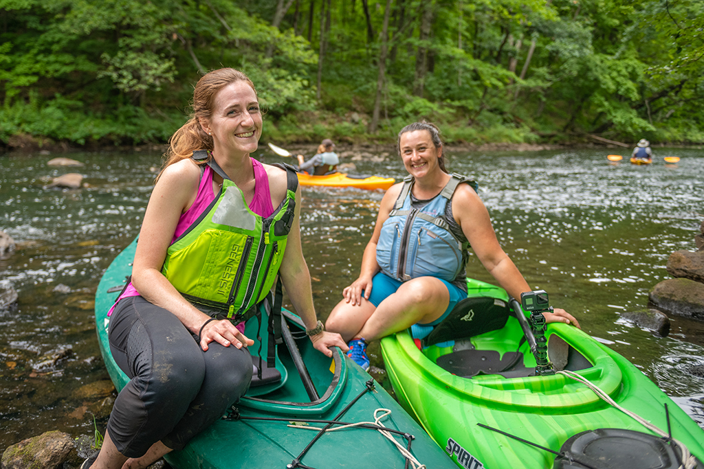 Katie Liming, M.S. ’22, and Stephanie Covino, M.S./ES&P ’15, on the Blackstone River.