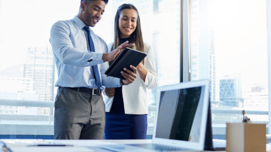 two people standing at desk