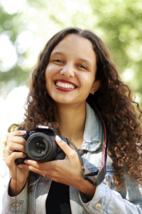 St.Clair Detrick-Jules holding camera