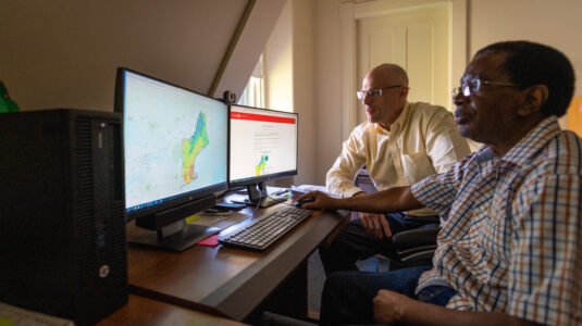 Two men sitting at computer