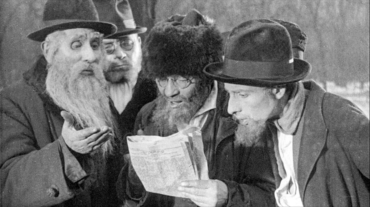 Screenshot of City Without Jews film, with old men reading newspaper