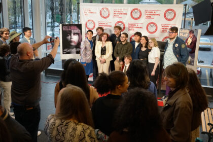 Students pose for a photo at the noir class's film debut.