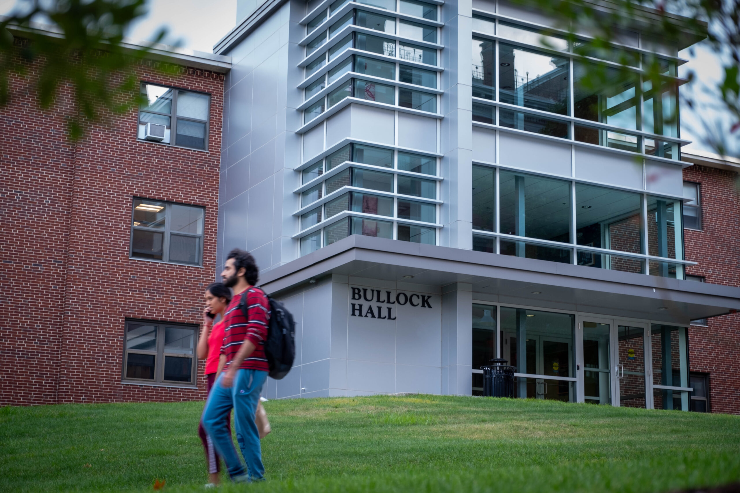 People walk past Bullock Hall.