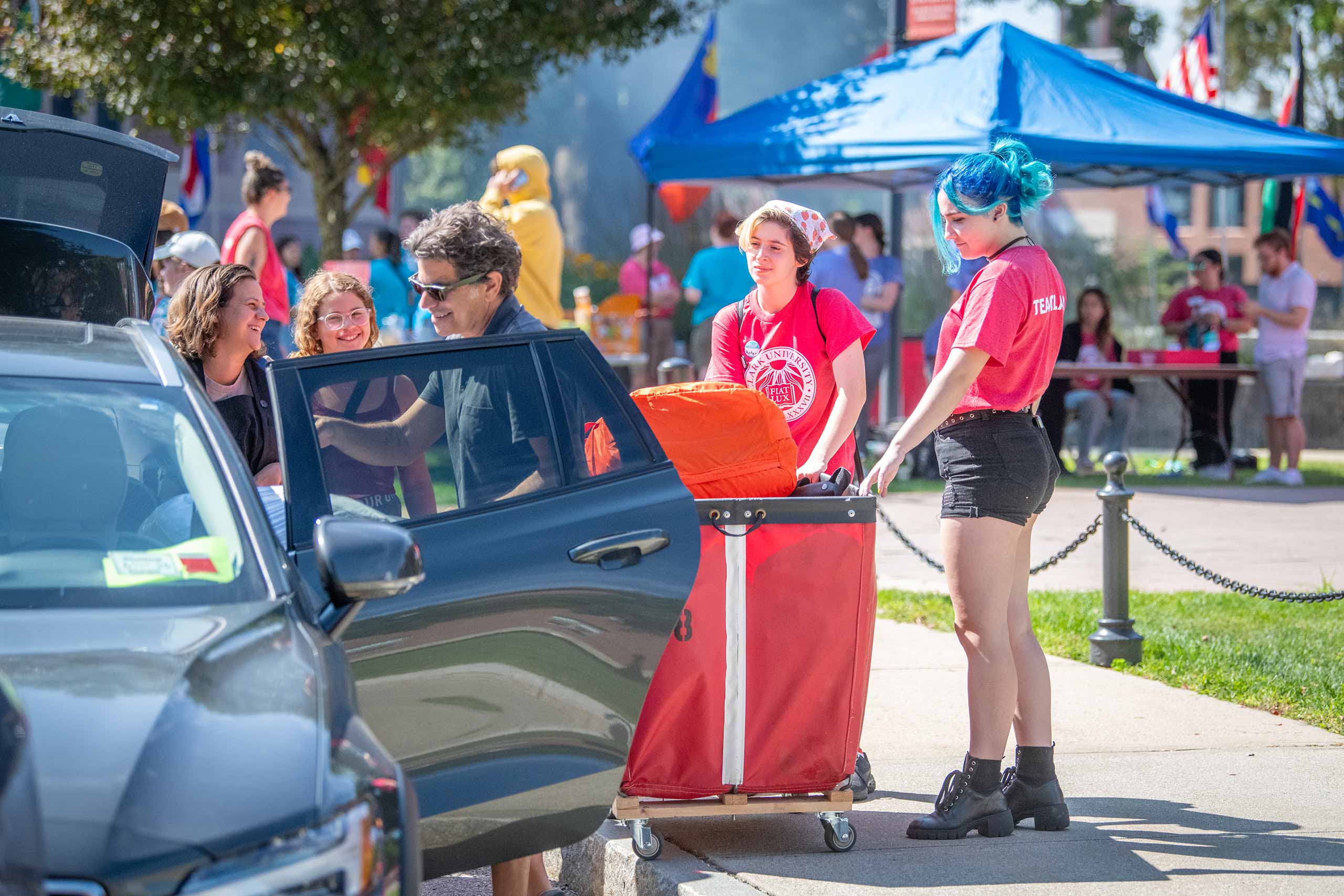 Students unloading belongings from a car