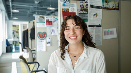 Emily Rooney sits in office