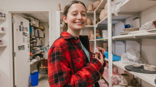 student holding clay figure