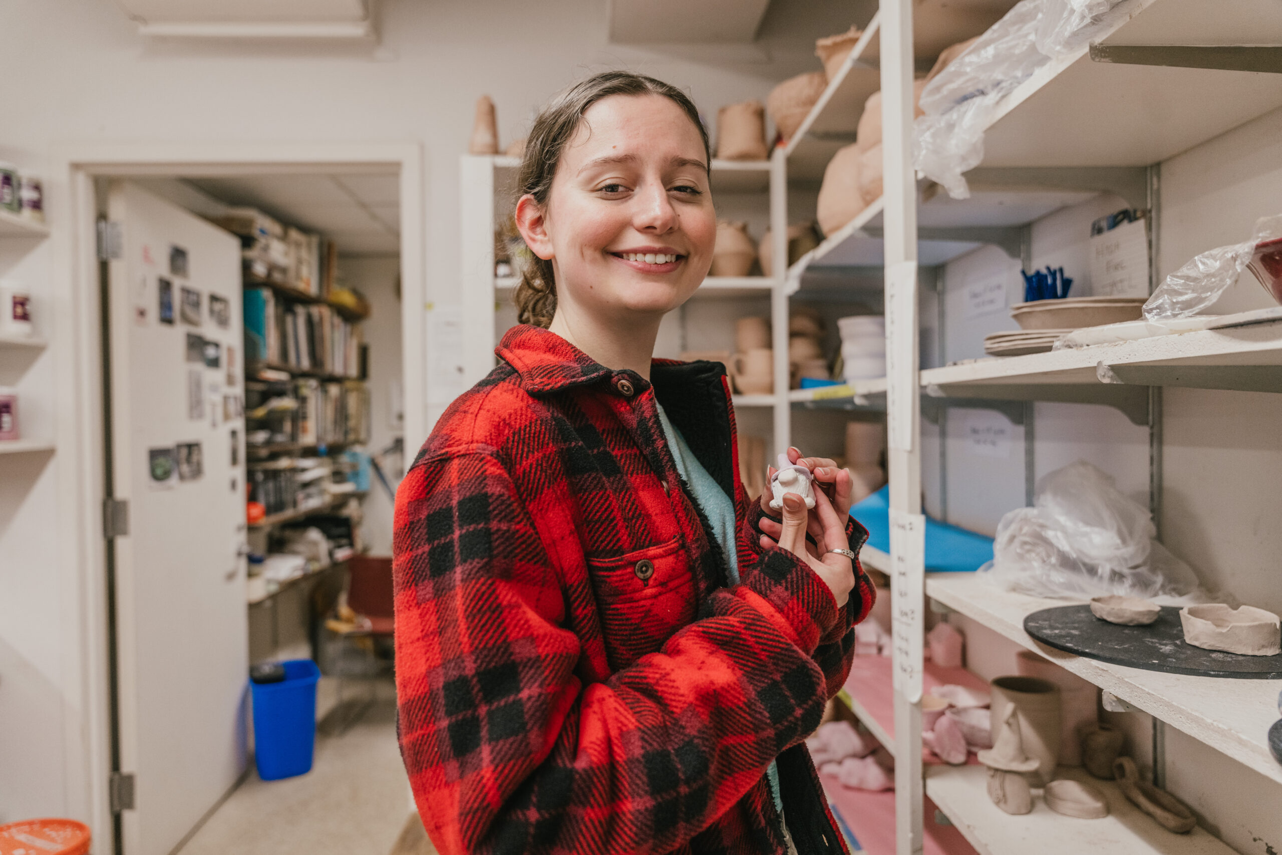 student holding clay figure