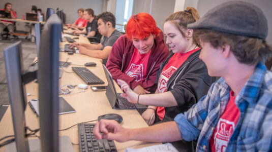 students at table with computers