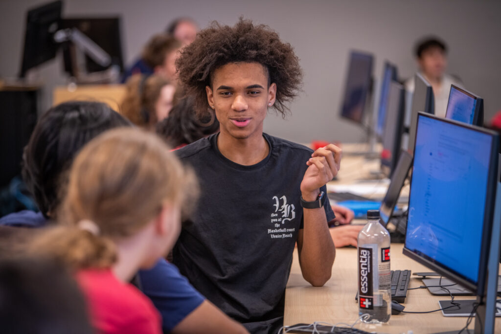 students at table with computers