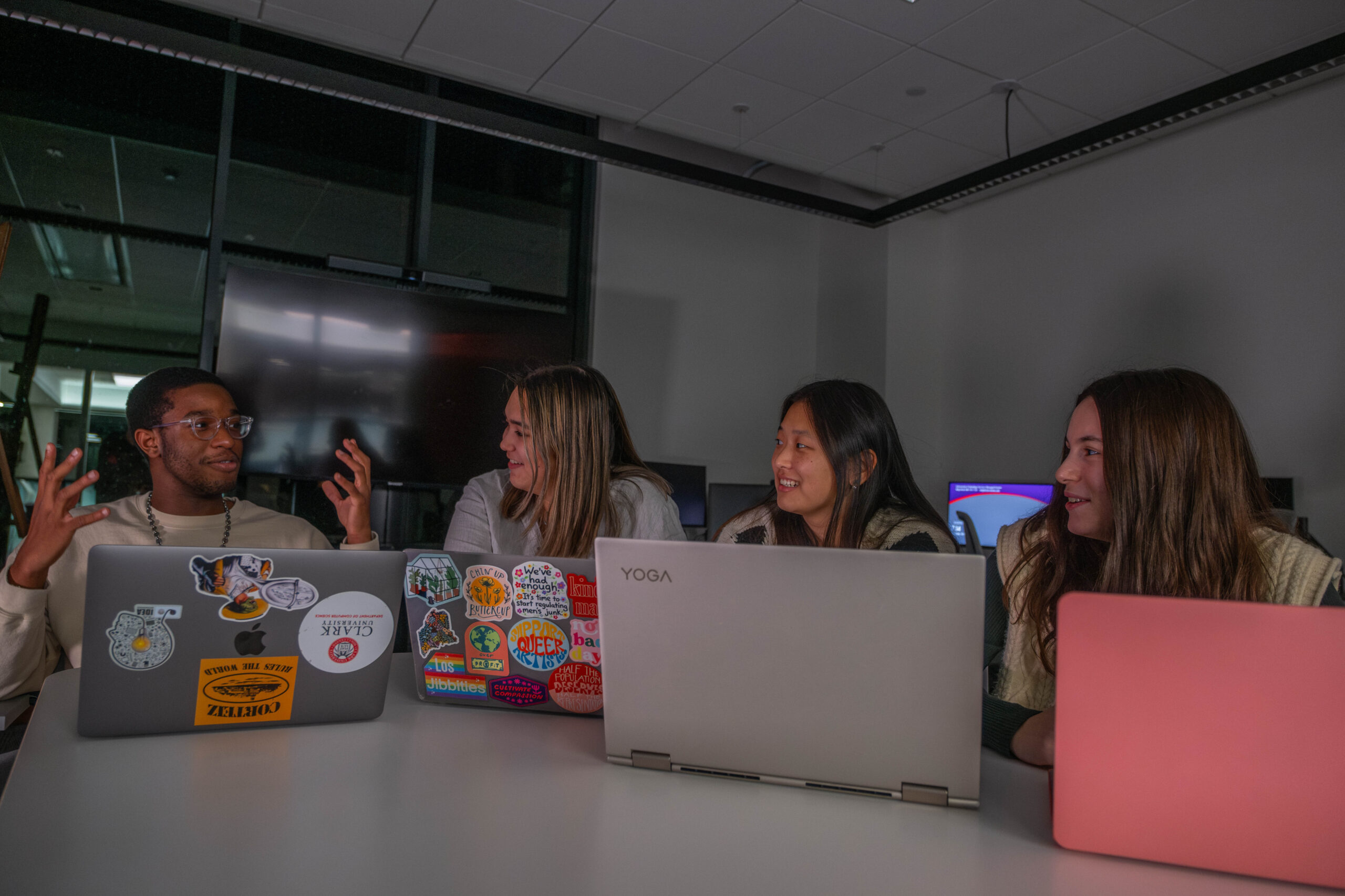 four students with laptops