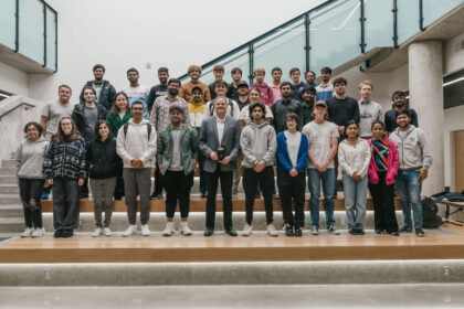 rows of students and professors pose for photo