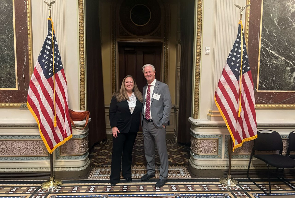 Professors Abby Frazier and Dave White standing inside a White House hallway