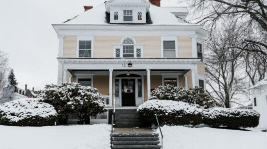 Yellow house in snow