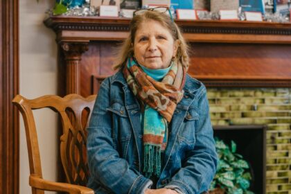 woman sitting in front of fire place