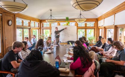 professor and students in room with whiteboard