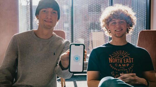 two students holding iPhone