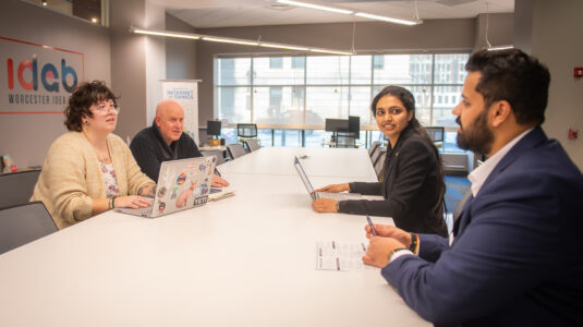 School of Management students Parimala Yerraguntla, M.S. ’25, and Aaryan Pankaj Dabhade, M.A. ’25 (right), meet at the Worcester Idea Lab with Margie Breault, Business & Community Advancement Manager for the City of Worcester in the Office of Economic Development, and Tom Herald, director of the Small Business Development Center at Clark University.