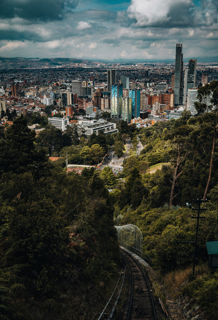 An aerial view of Bogotá, Colombia with green woodland landscape in the foreground