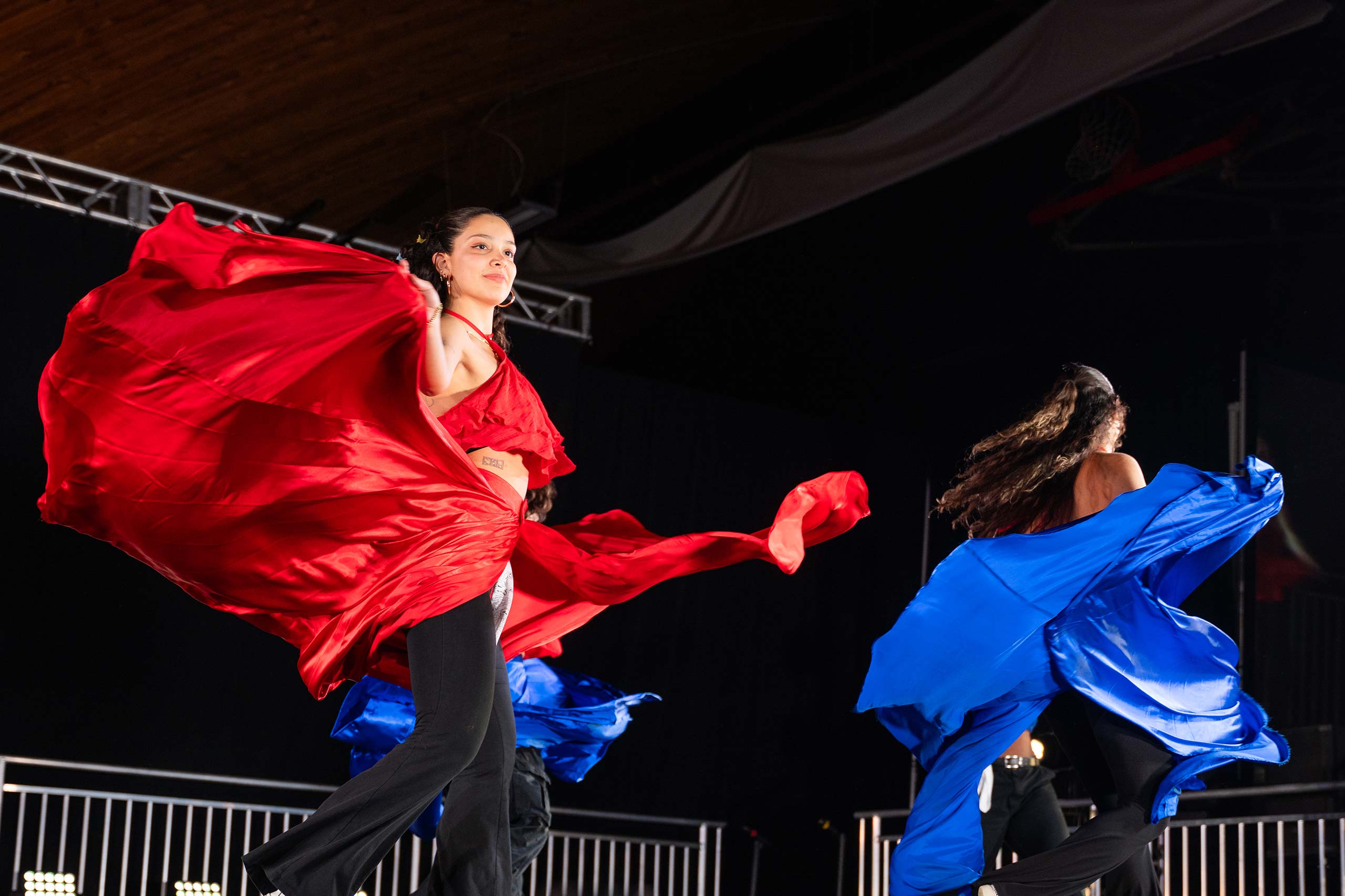 Students wave the brightly colored fabric of their costumes during a performance at the 2024 Gala event