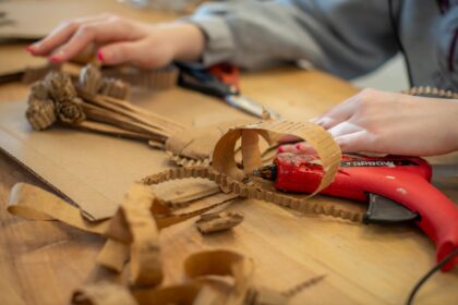 cardboard scraps on table with glue gun