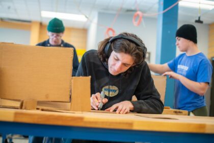 student crafting with cardboard