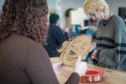 student crafting with cardboard