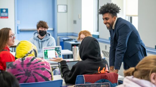 professor talks to students in classroom