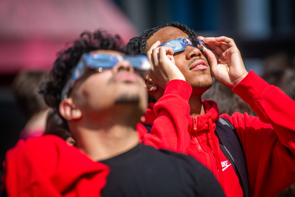 Students watch the partial solar eclipse on April 8, 2024, on the Clark University campus