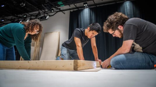 students drilling wood