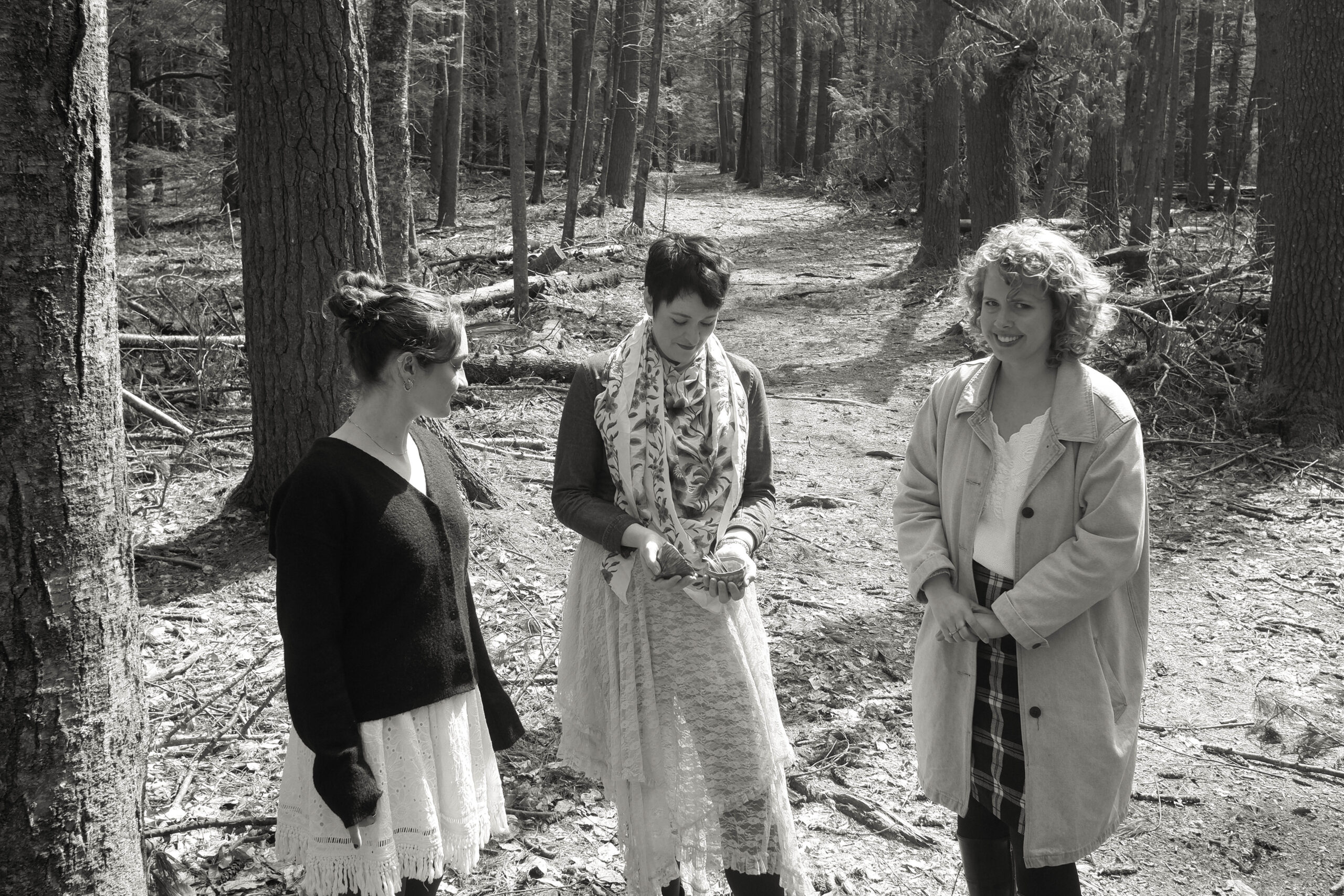 women standing in woods