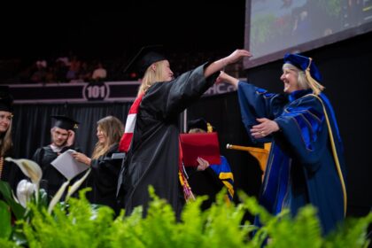 mother and daughter hug at commencement