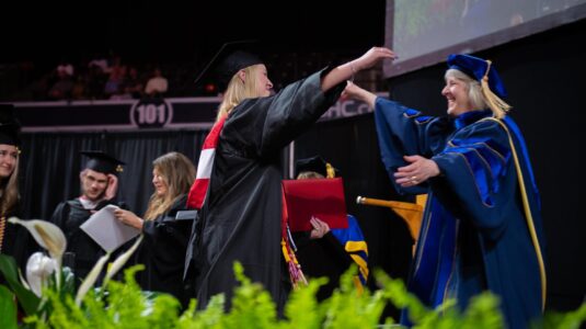 mother and daughter hug at commencement