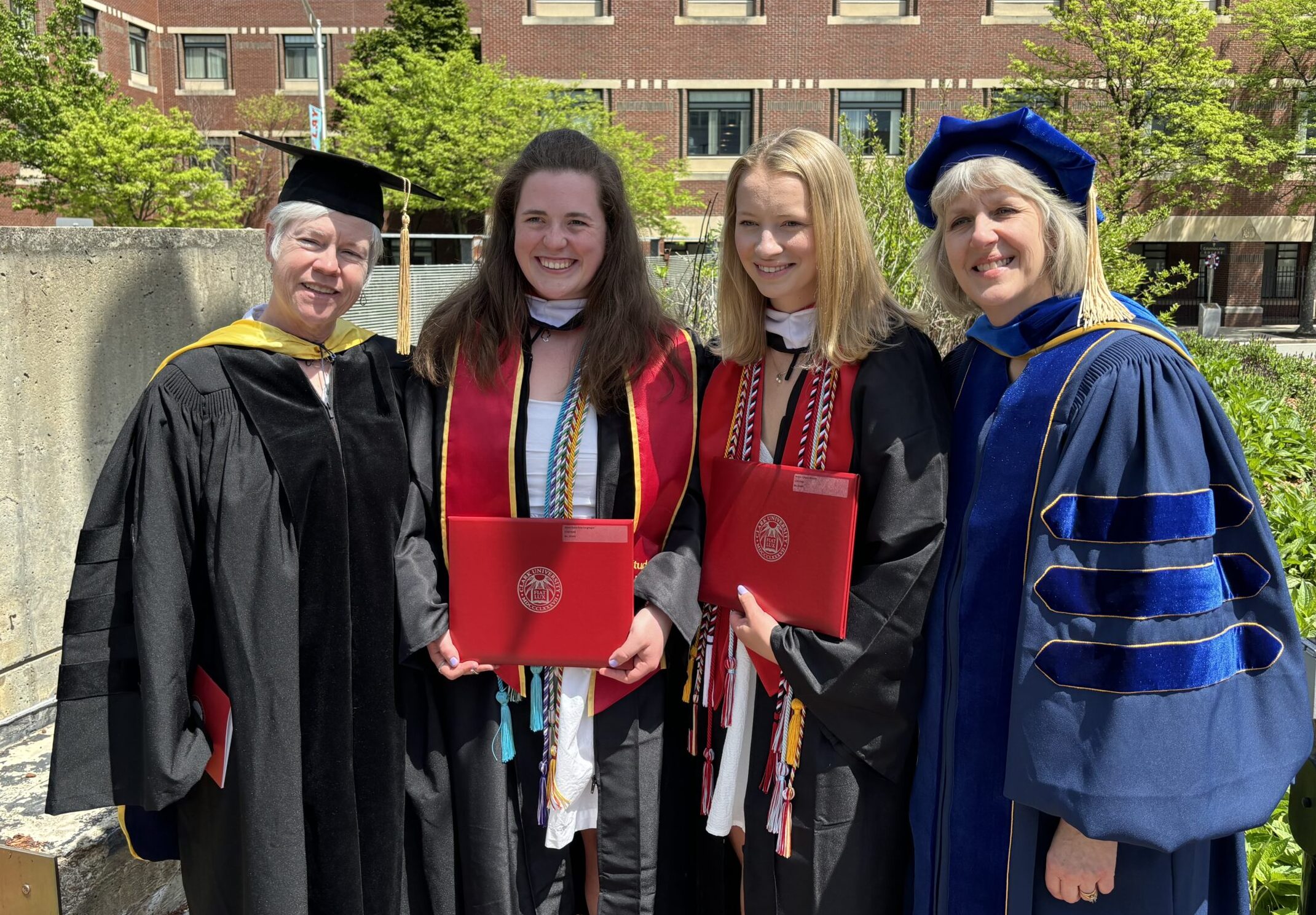 two mothers and two daughters pose at graduation