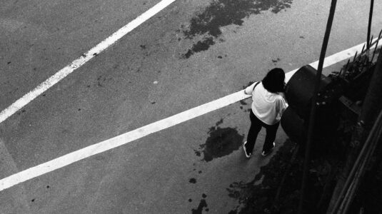 woman walks on road