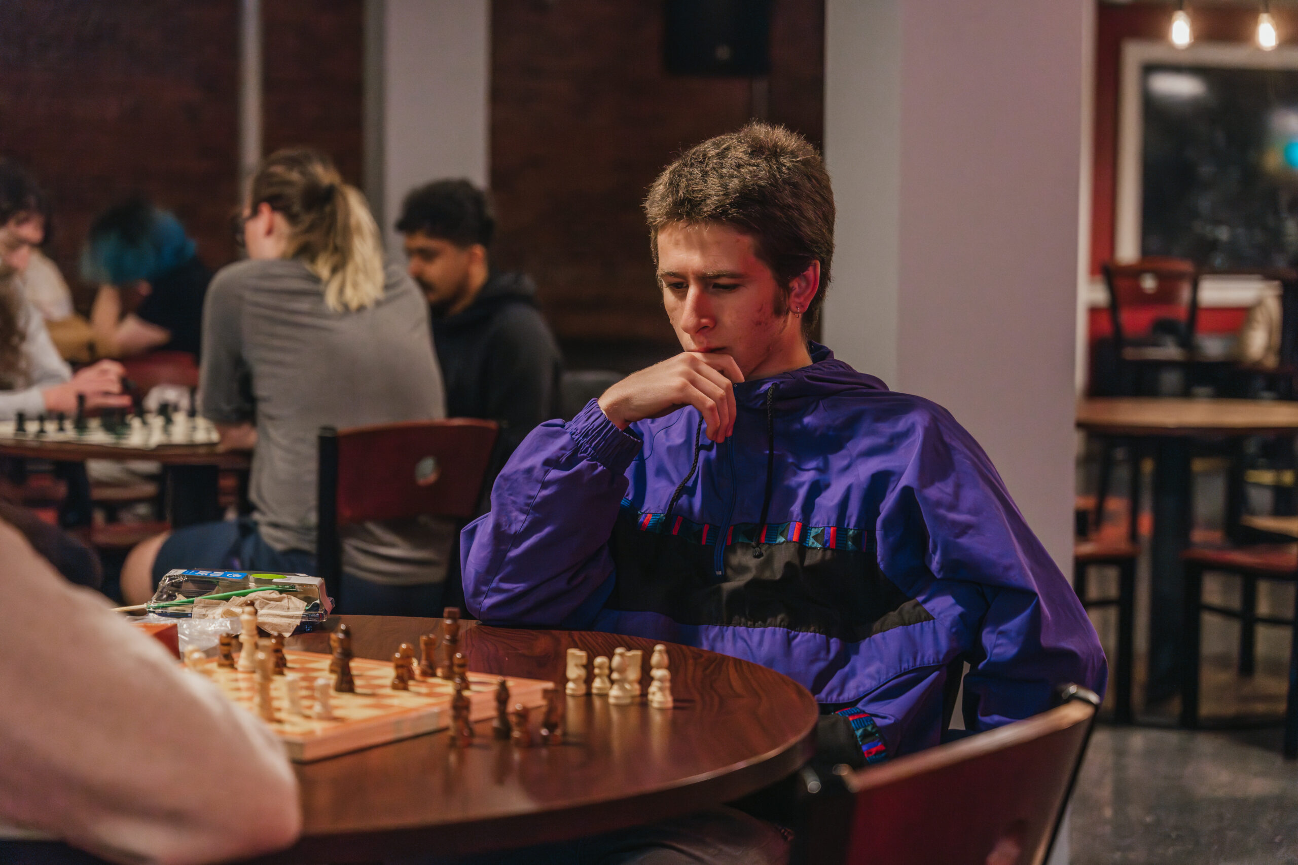 student in front of chess board