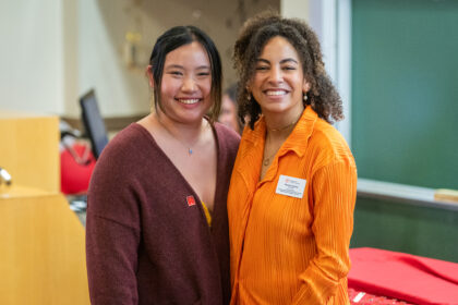 student and woman pose for photo