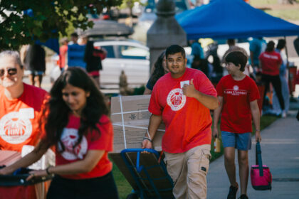 students with bins on move-in day