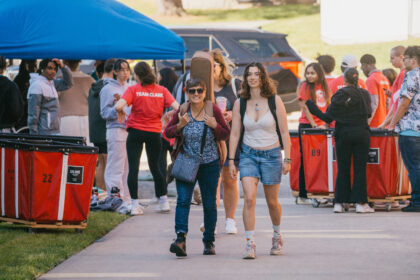 student and parent walk on walkway