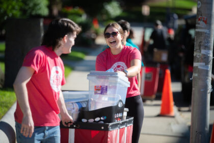 students with bins on move-in day