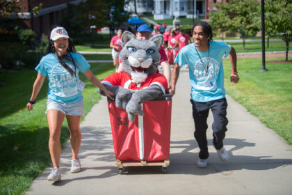 students with bins on move-in day