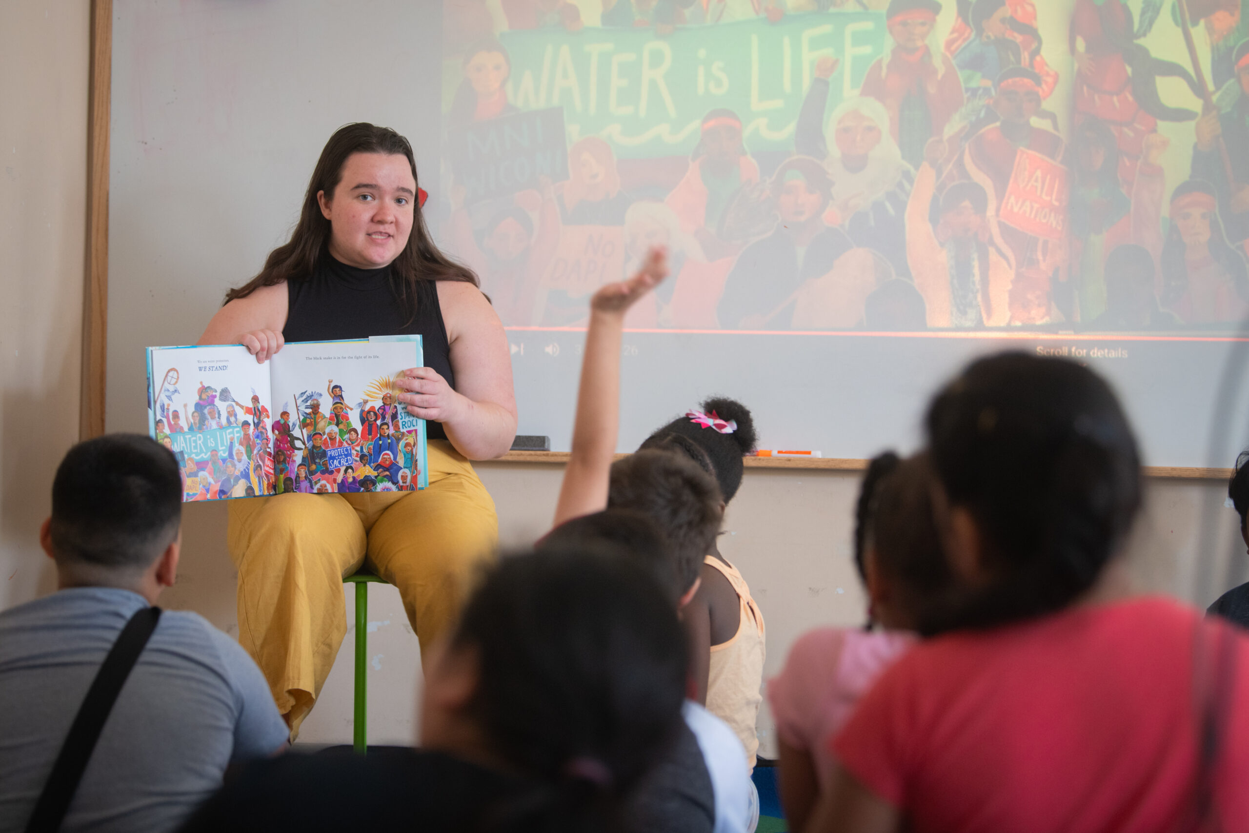 student teacher in classroom with elementary schoolers